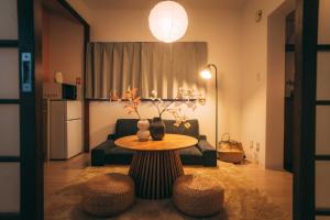 a living room with a table and a couch at リトリートコート薬院 in Fukuoka