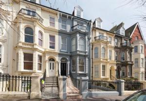 a large house with a person standing in front of it at Westbourne Hotel and Spa in Brighton & Hove