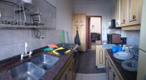 a kitchen with a sink and a counter top at ATLAS - San Telmo in Buenos Aires