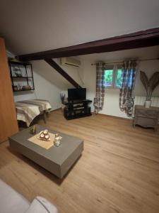 a living room with a couch and a table at Nice studio in Paris suburbs in Épinay-sur-Seine