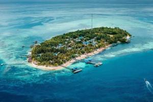 an island in the ocean with boats in the water at Walking Shark Guest House in Besir +43 photos