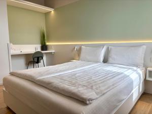 a bedroom with a large white bed with a desk at Palazzo Betteloni in Bardolino +67 photos