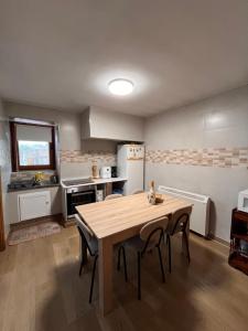 a kitchen with a table and chairs in a room at CASA DA TORRE in O Grove