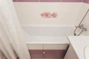 a bathroom with a shower with a flower on the wall at Apart-Kharkovskaya in Sumy