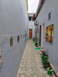 a hallway of a building with plants on the walls at Pousada Massayó in Maceió