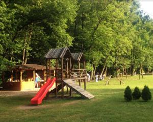 a playground with a slide in a park at Vikendica Anastasija in Laktaši