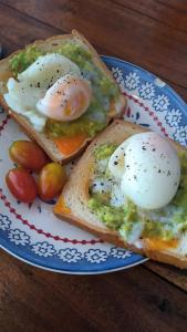 two slices of toast with eggs on a plate at Chalok Hostel in Koh Tao +14 photos