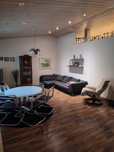 a living room with a couch and a table and chairs at Santa Claus House in Rovaniemi