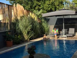 two children playing in a swimming pool at One Suit in Kartepe