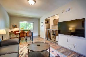 a living room with a couch and a tv and a table at Pet Friendly Free Parking Near Medical Center in West Allis