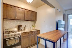 a kitchen with wooden cabinets and a wooden table at Pet Friendly Free Parking Near Medical Center in West Allis +8 photos