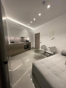 a hotel room with a bed and a kitchen at SeaNest Bali in Bali +9 photos
