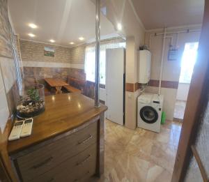 a kitchen with a refrigerator and a washing machine at Хостел Твій Дім в Пирятині in Pyryatyn