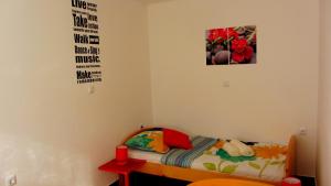 a bedroom with a bed and a picture on the wall at Apartment Marin in Ogulin