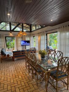 une salle à manger avec une table et des chaises en verre dans l'établissement Holiday Villa Praia da Pipa-5 Suites,Areá Gourmet by PipaCharme, à Pipa