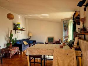 a living room with a table and a couch at Casa Mare & Monti in Caprauna