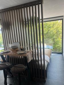 a room with a bed and a table with chairs at Tea House Ponoarele in Ponoarele
