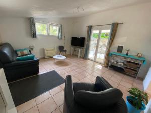 a living room with two couches and a tv at le lavandin in Lorgues