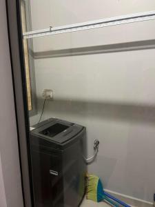 a bathroom with a toilet with a sink and a mirror at Mickey home's in Ho Chi Minh City