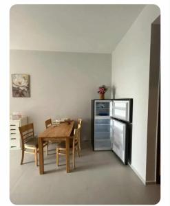 a dining room with a table and a refrigerator at Mickey home's in Ho Chi Minh City