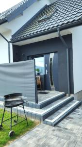 a patio with stairs and a table in front of a house at Pod Chmurką in Solina