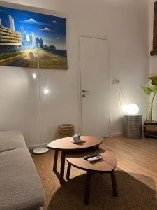 a living room with a couch and a coffee table at Stylish Garden Apt 2 Min Beach in Tel Aviv