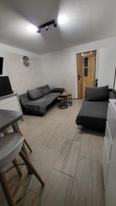 a living room with a couch and a table at Pod Chmurką in Solina +2 photos