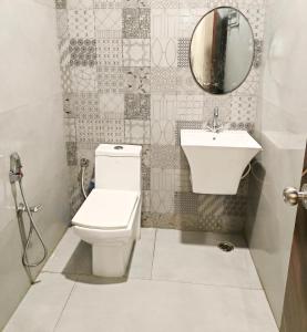 a bathroom with a toilet and a sink at A2 Villa by JMD - Peaceful Stay Near Expo Mart in Greater Noida