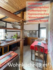 a kitchen with a table with a red table cloth at Romantische und museal eingerichtete Ferienwohnung in Stein