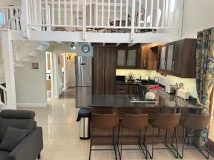 a kitchen with a large island in a living room at The Cottage - a tranquil hideaway in Somerset West