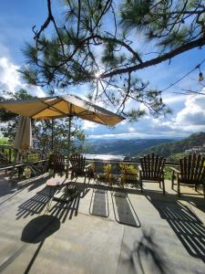 a patio with chairs and an umbrella and a view at Mây Nhà Tuii - Homestay in Da Lat in Ấp Ða Lợi +43 photos