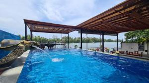 a swimming pool with an elephant spraying water into it at Amber House Lanka in Bentota