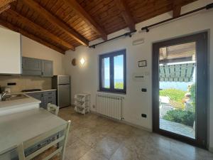 a kitchen with a door leading to a patio at Villa Rosi&Maria in Coccorino