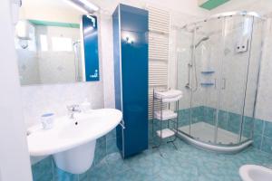 a bathroom with a sink and a shower at Amarin Pisa Room in Pisa