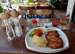 a plate of food with meat and vegetables on a table at The Deck in Phnom Penh