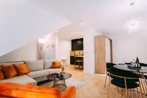 a living room with a couch and a table at GOLD PTAK Apartment in Nowy Sącz