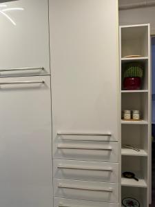 a white refrigerator with its doors open in a kitchen at Central Bliss 3 rooms in Iaşi +13 photos