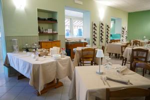 a dining room with tables with white tablecloths at Locanda dal Giangi in Quargnento