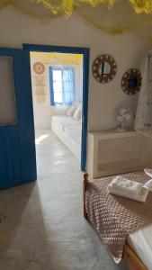 a bedroom with a bed and a door with a mirror at Syrma Sunset Areti in Kástron +4 photos