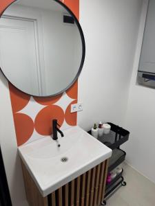 a bathroom with a sink and a mirror at White Sand Studio in Pāvilosta +1 photo