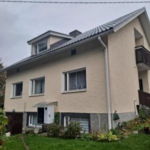 a house with two windows and a roof at Niittytie Alexsandra in Kuopio