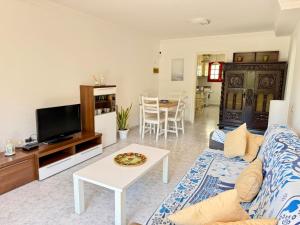a living room with a couch and a table at Mar de Luna in Puerto Rico de Gran Canaria