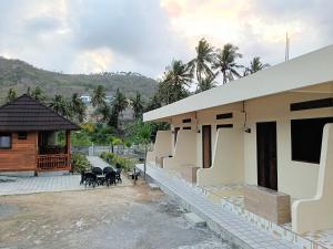a house with a patio and a building at Mandalika Queen Studio in Kuta Lombok