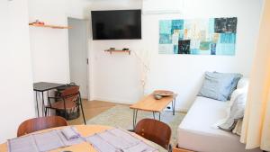 a living room with a couch and a table at Kalumi in Vila Nova de Milfontes