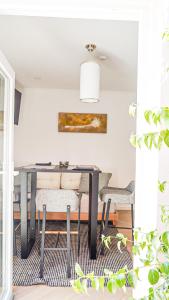 a dining room with a table and chairs at Kalumi in Vila Nova de Milfontes