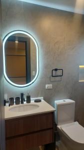 a bathroom with a sink and a mirror at Prados del Oeste in Cochabamba