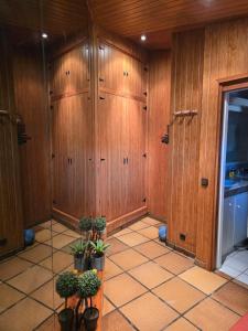 a room with wooden cabinets and potted plants in it at Can Marisu, Casita privada in Cabrils