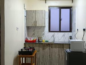 a kitchen with a sink and a counter with a window at AceStudio Kikuyu with Parking and Lift in Kikuyu