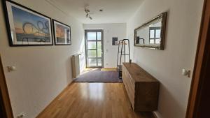 a hallway of a home with a wooden floor at Quartier Levi in Oberhausen