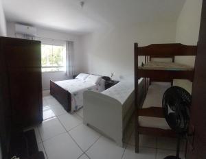 a bedroom with a bed and a bunk bed at Pousada Agradável Pomerode in Pomerode